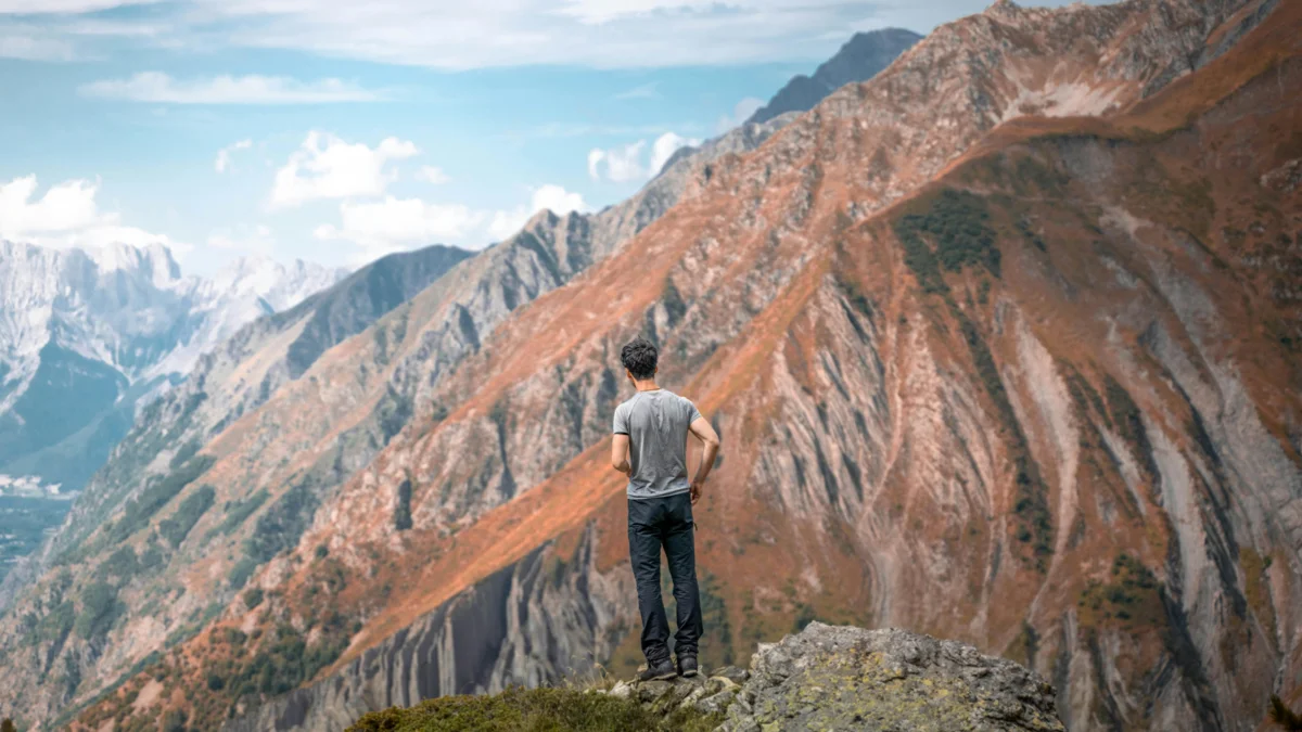 Person standing on mountain peak